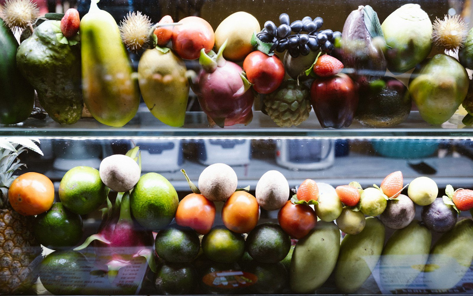 A display case filled with lots of different types of fruit